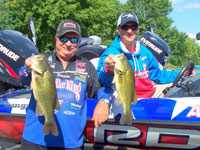 Chad Brauer and Denny Brauer, 1998 Bass Masters Classic Champion, holding their fish